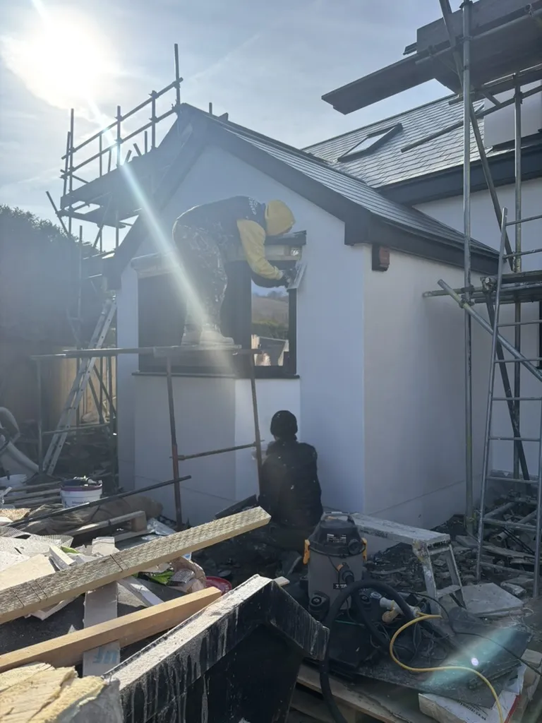 Fresh render drying on the test project&rsquo;s rear elevation.