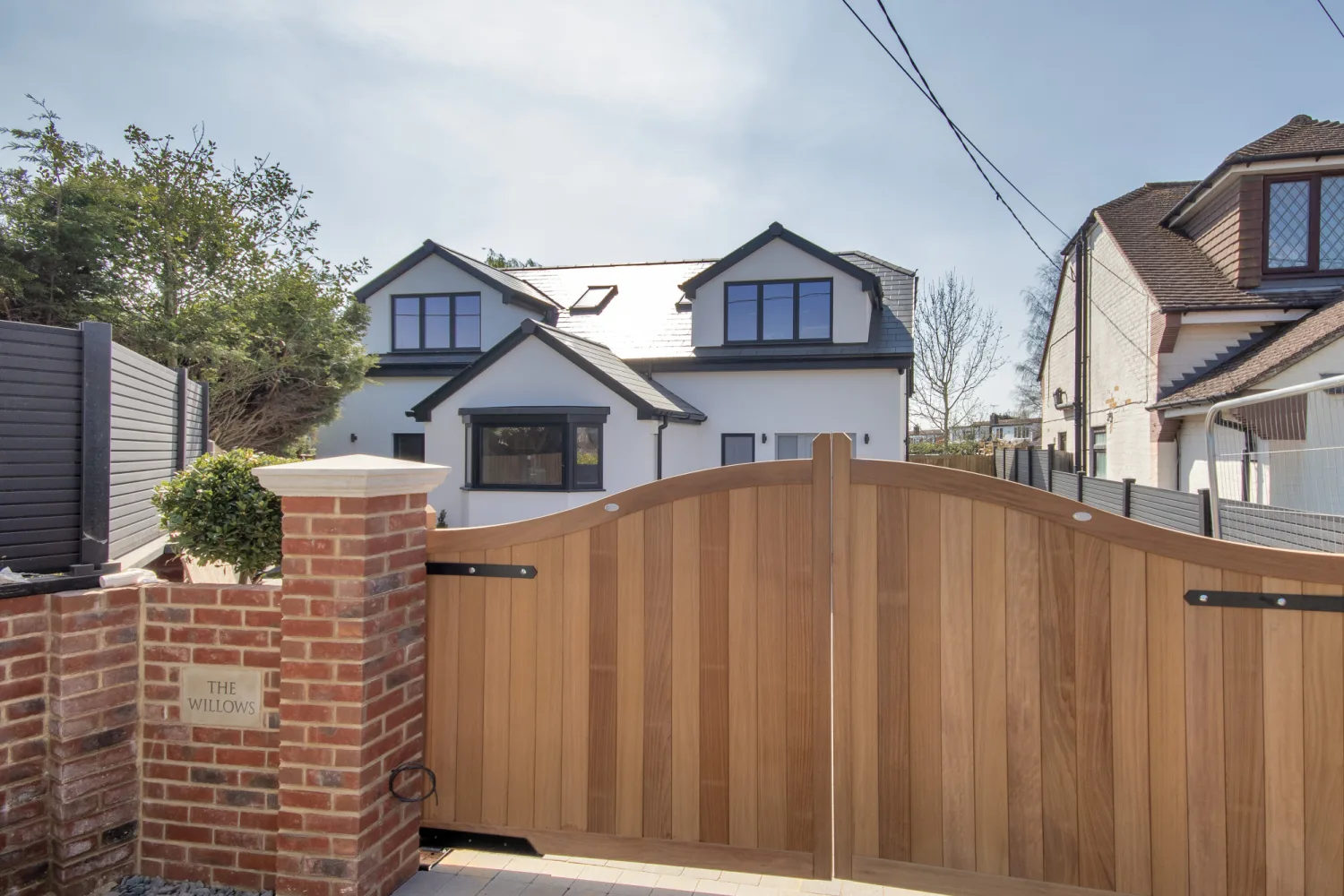 A completed UK residential development behind its new entrance gates — the test project at handover.